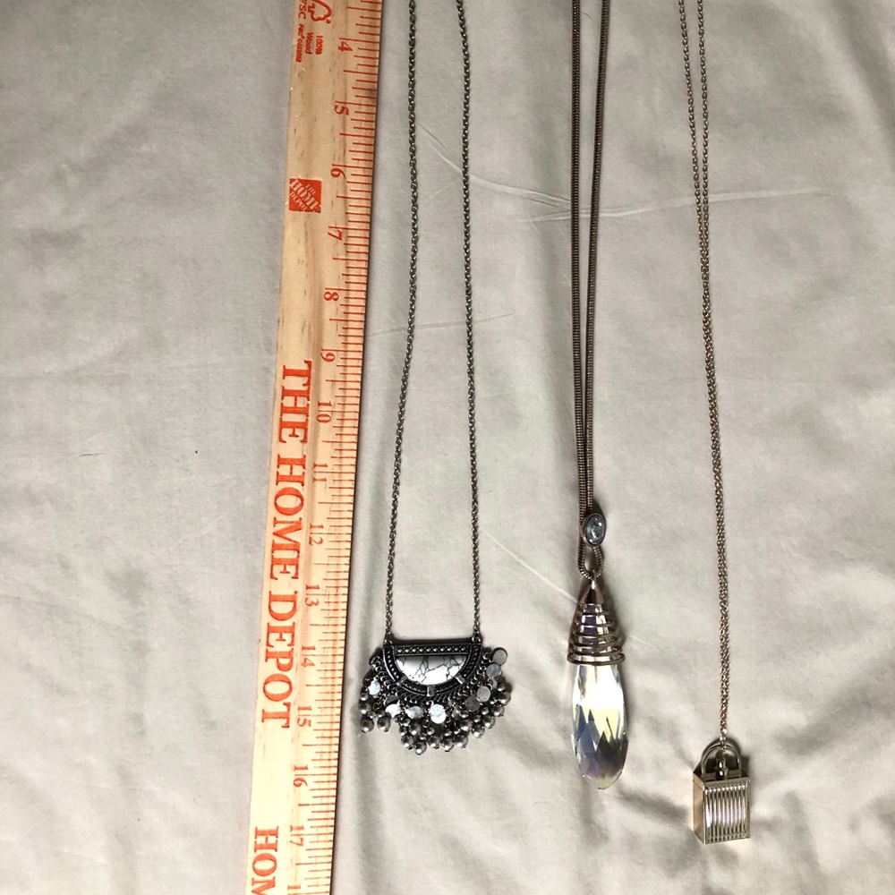 3 long necklaces and one is Chloe